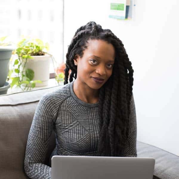 Smart woman working on laptop for land and property insights at Land Guy Online.