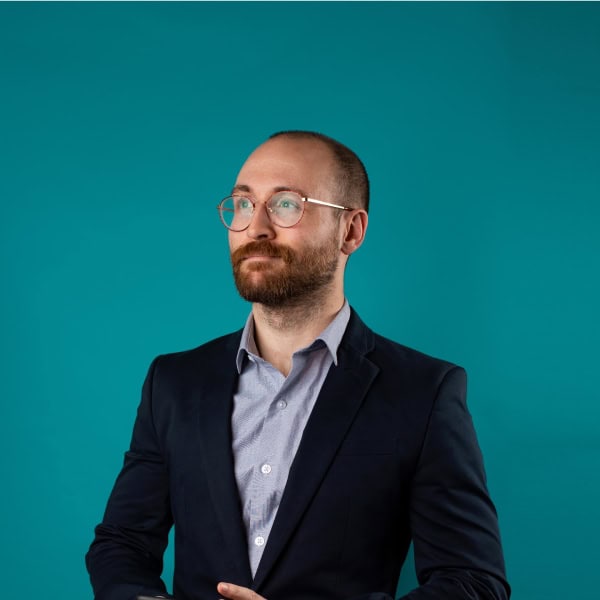 Professional land expert in business attire with a confident pose for land development.